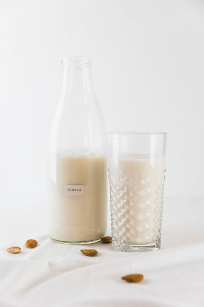 bottle and glass of milk with nuts