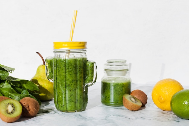 Bottle of green smoothie with fresh fruit