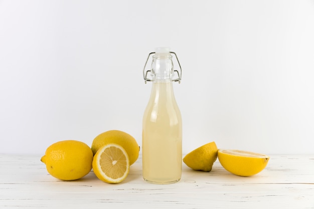 Bottle of homemade lemonade on table