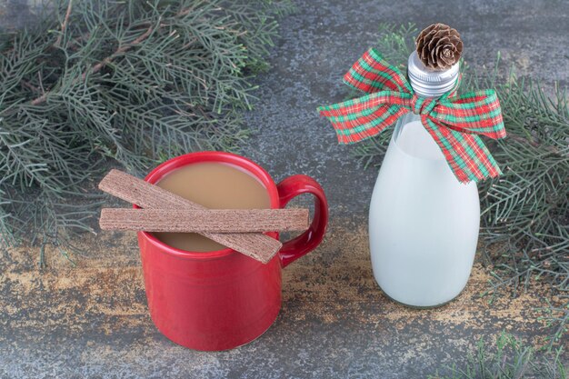 A bottle of milk with bow and glass on marble background. High quality photo