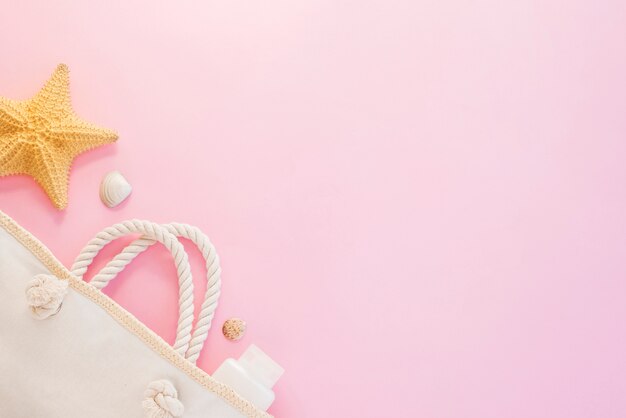 Bottle near seashells with starfish and bag