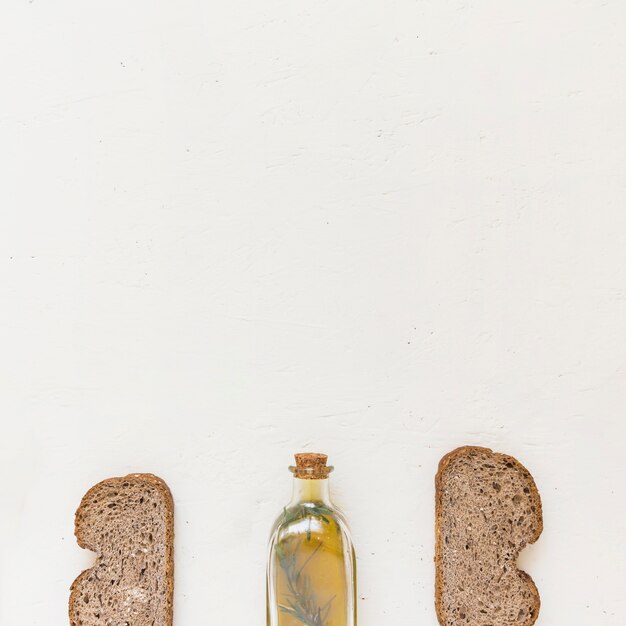 Bottle of oil with slices of bread 