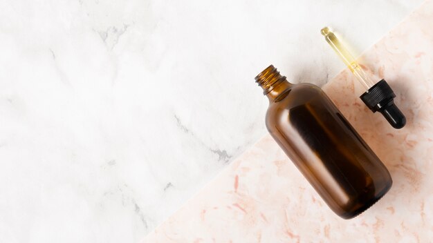 Bottle for oils on marble background