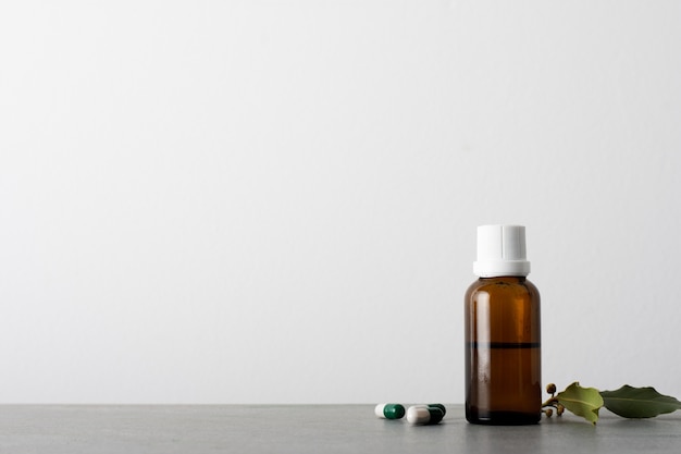 Bottle of organic oil with capsules on the table