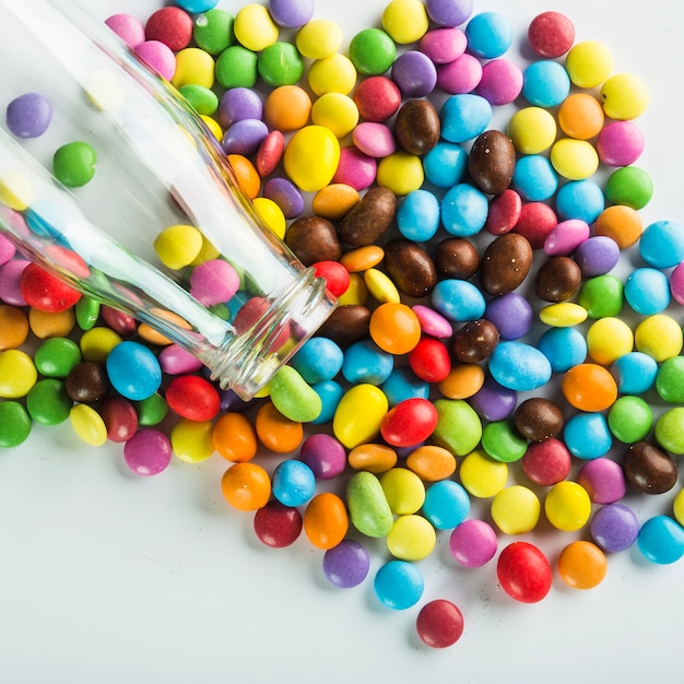 Bottle on pile of candy buttons