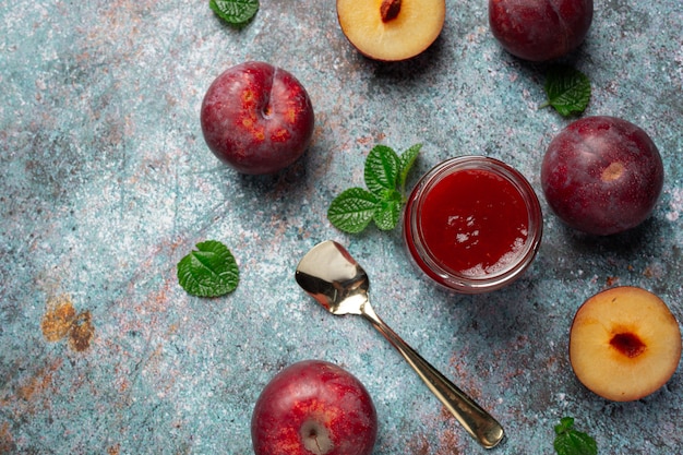 Free photo bottle of plum jam  put on dark floor