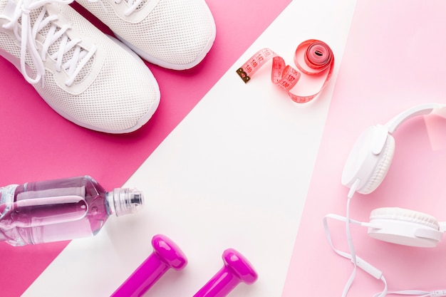 Bottle of water weights headphones and sneakers