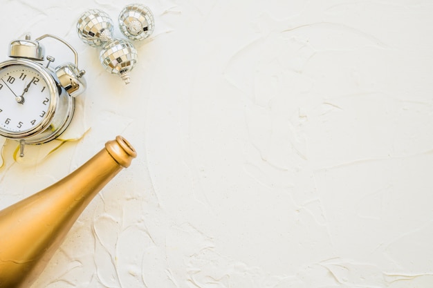 Free photo bottle with clock on white table