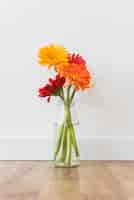 Free photo bottle with flowers standing on floor