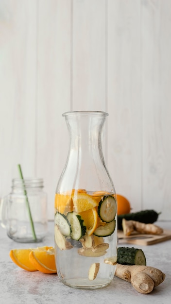 Free photo bottle with water, citrus and cucumber