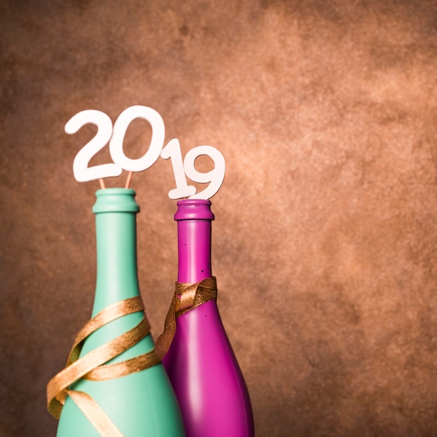 Bottles of beverage with 2019 numbers on wands