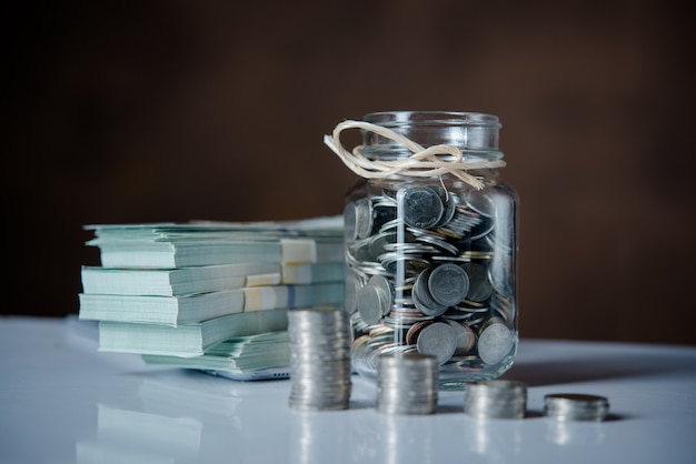 Bottles of cash with coins in saving money concept Free Photo