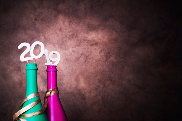 Bottles of drink with 2019 numbers on wands 