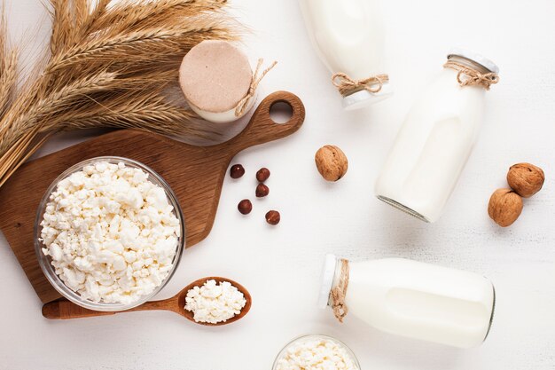 Bottles filled with milk and cheese wheel