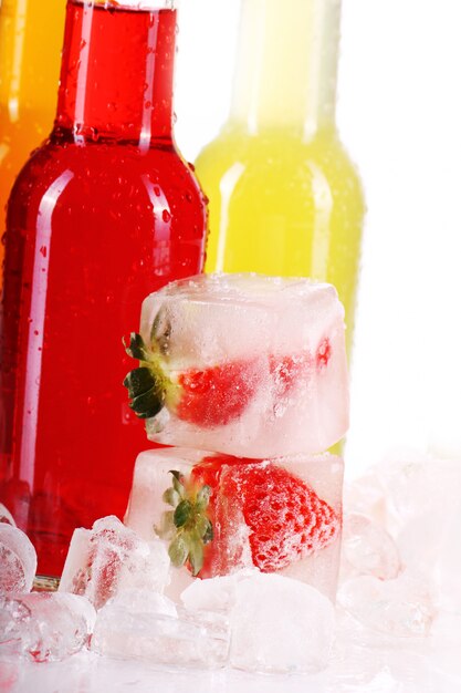 Bottles with colorful cocktail and ice