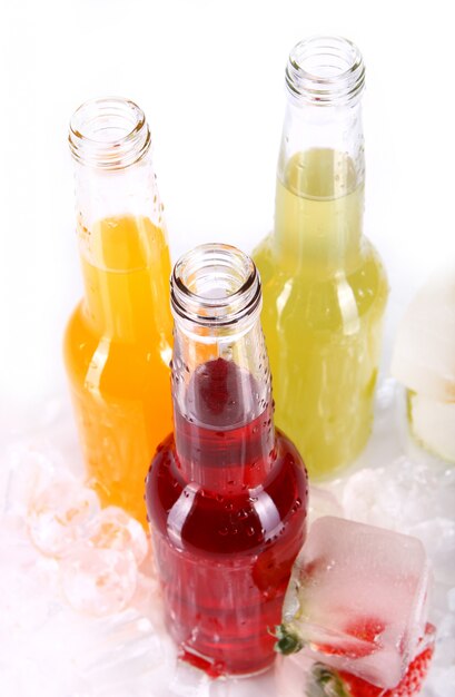 Bottles with colorful cocktail and ice