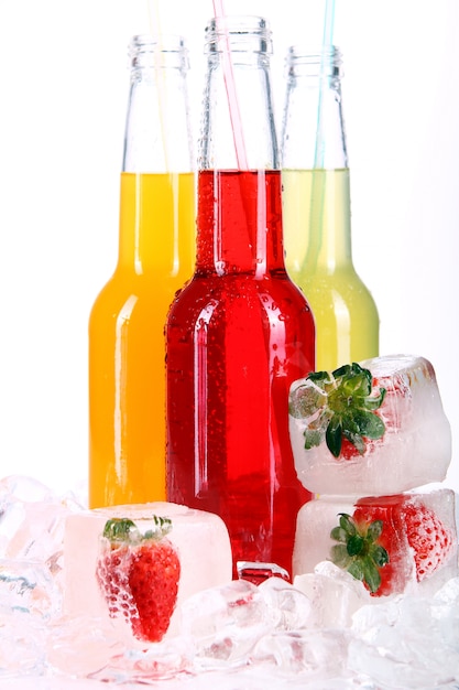 Bottles with colorful cocktail and ice