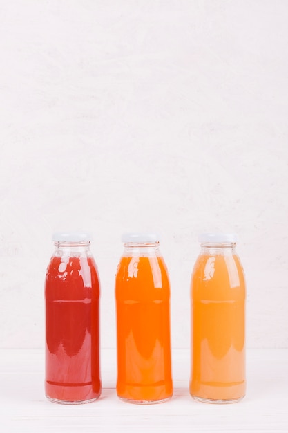 Bottles with colorful fruit juice