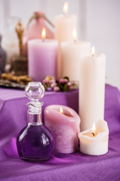 Bottles with essential aroma oil and aroma candles. Spa setting