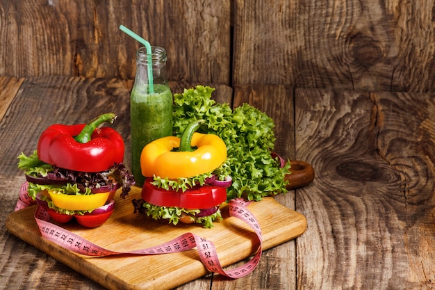 The bottles with fresh vegetable juices on wooden table