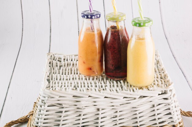 Bottles with smoothie on basket