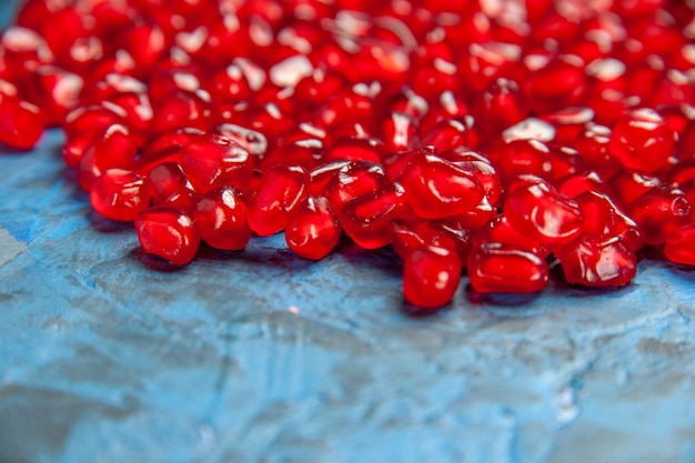 Bottom close view pomegranate seeds on blue free place