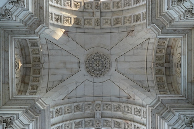 Bottom view of arched ceiling with sculptures in commercial square lisbon portugal