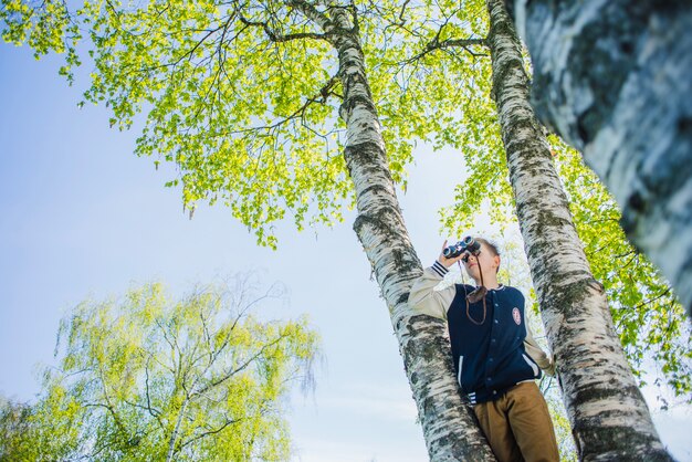 Bottom view of boy using binoculars