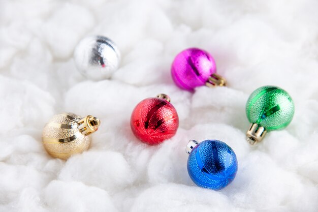 Bottom view colorful xmas tree balls on white surface