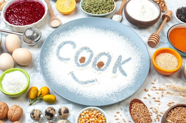 Bottom view cook imprint on powdered flour on blue round plate and other stuffs on white table