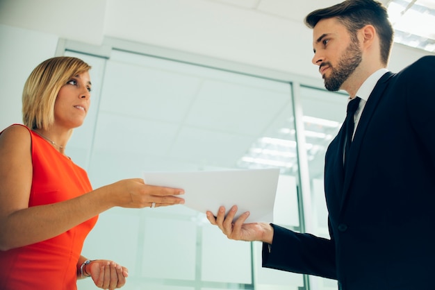 Free photo bottom view of coworkers holding the same documents