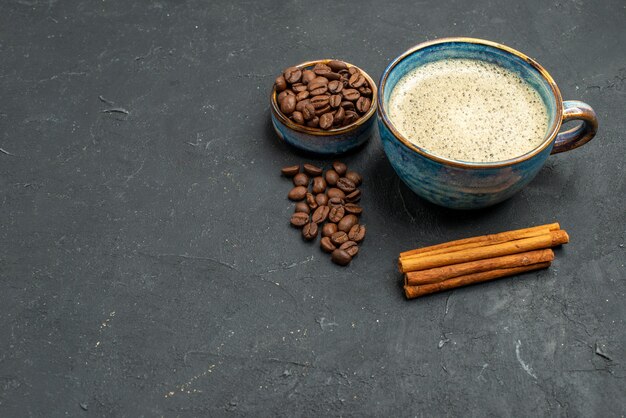 Bottom view a cup of coffee bowl with coffee seeds cinnamon sticks on dark free place