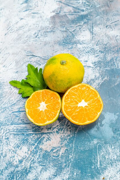 bottom view cut mandarins on blue white surface free space