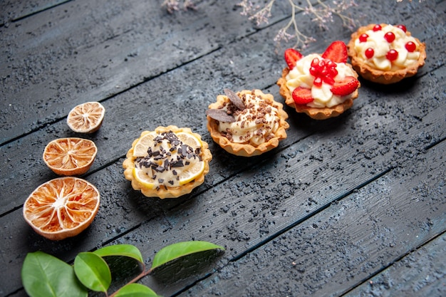 Bottom view different tarts dried oranges leaves on dark background