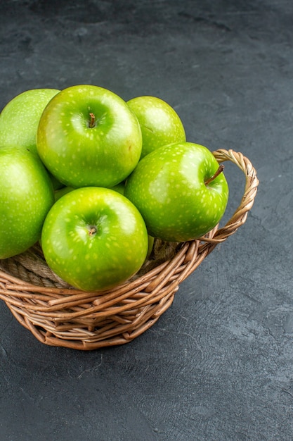 Free photo bottom view fresh apples in wicker basket on dark surface