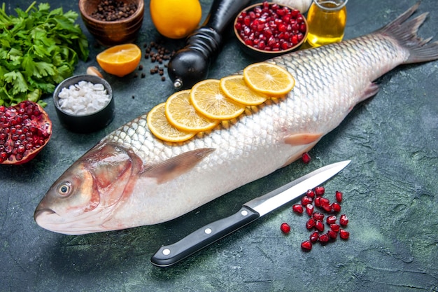 Bottom view fresh fish with lemon slices knife on kitchen table