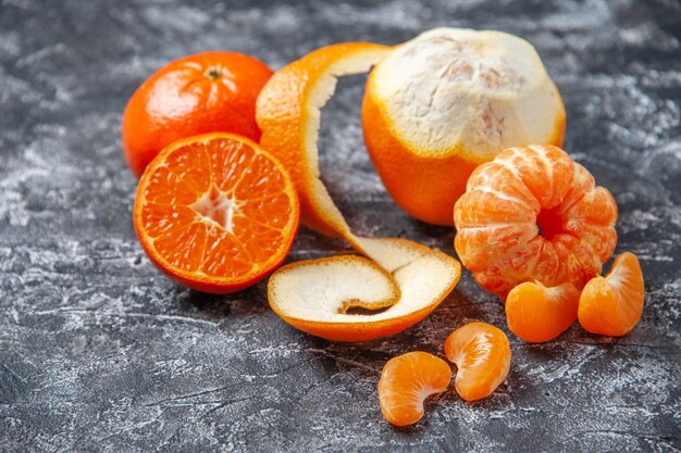 Bottom view fresh mandarins peeled mandarins on grey background