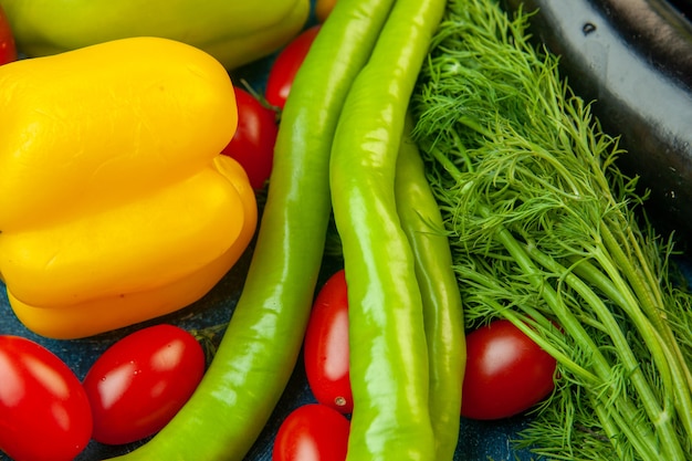 Bottom view fruits and vegetables bell peppers dill hot pepper cherry tomatoes on blue table