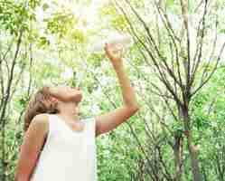 Free photo bottom view of girl drinking water