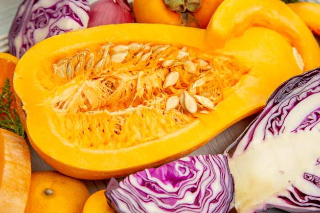 Free photo bottom view half butternut squash red cabbage persimmons