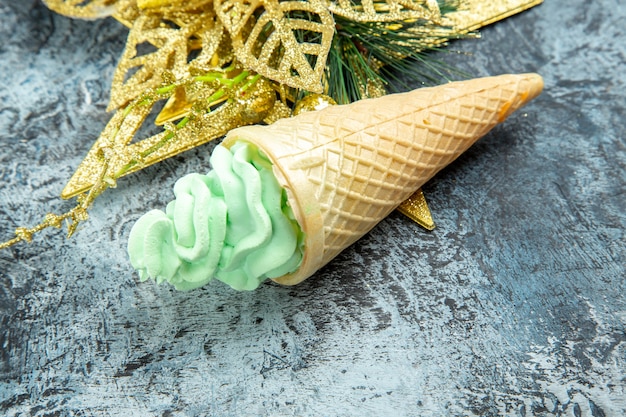 Bottom view ice cream golden xmas ornament on grey background