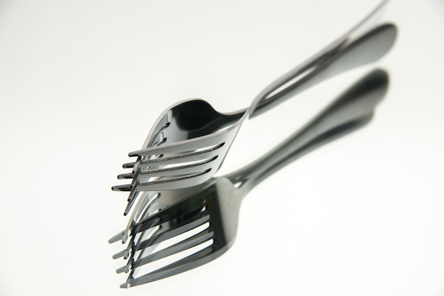 Bottom view pair of forks with reflection in the mirror