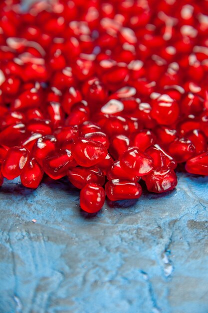 Bottom view pomegranate seeds on blue free place