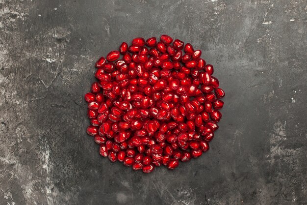 Bottom view pomegranate seeds on dark table free space