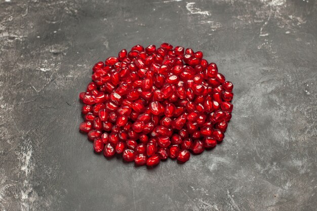 Bottom view pomegranate seeds on dark table