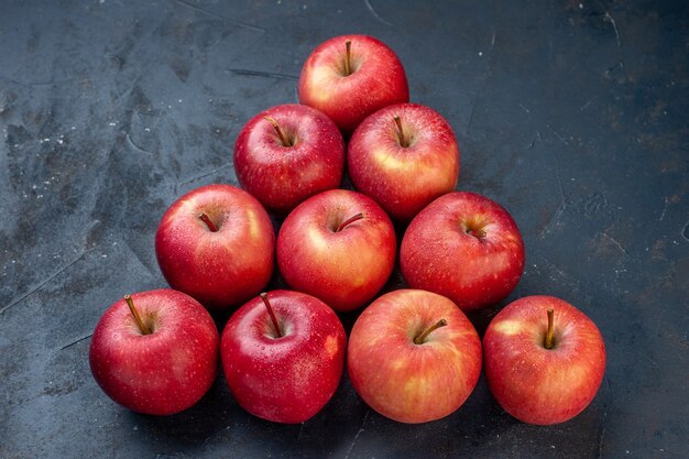 Bottom view pyramid fresh red apples on dark table free space