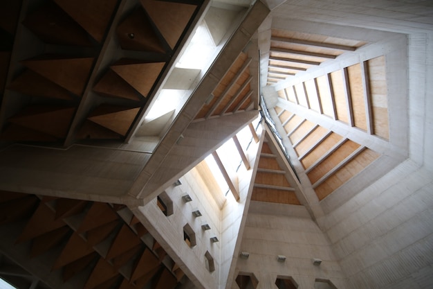 Bottom view shot of a white and brown building roof from inside