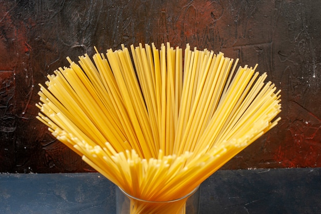 Bottom view spaghetti in glass on dark table