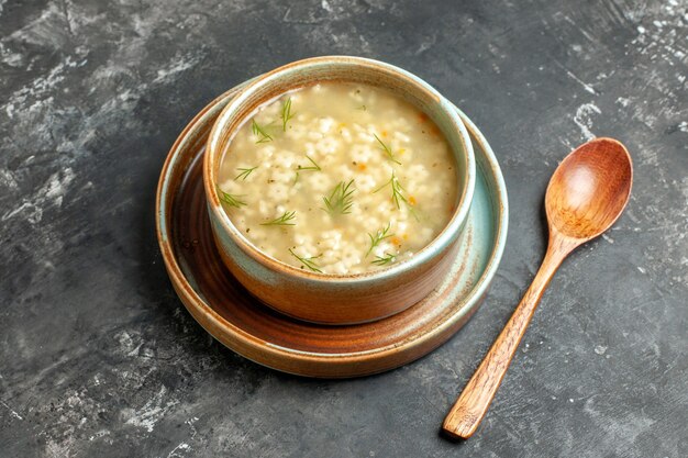 Bottom view star soup in bowl wooden spoon on dark background