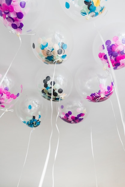 Bottom view transparent balloons with confetti inside